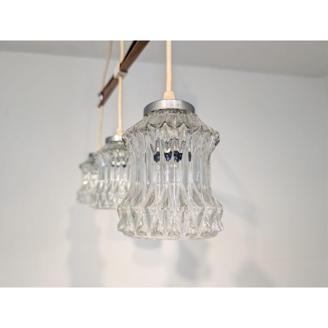 Teak Pendant with Ribbed Glass Shades from the 1960s/1970s Stylish, retro-style glass shades from the 1960s and 1970s....