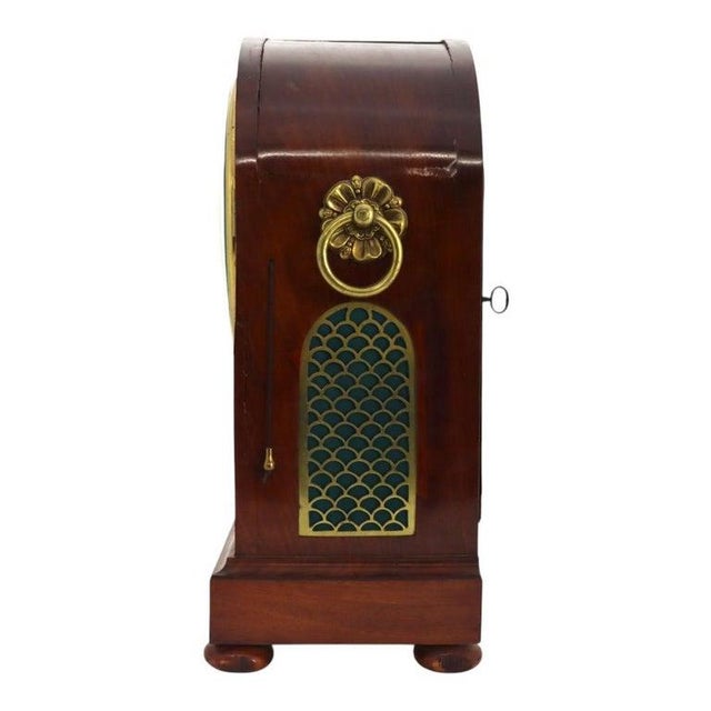 An antique English Regency bracket clock by Frodsham of London, dating to circa 1820. This handsome timepiece is housed in...