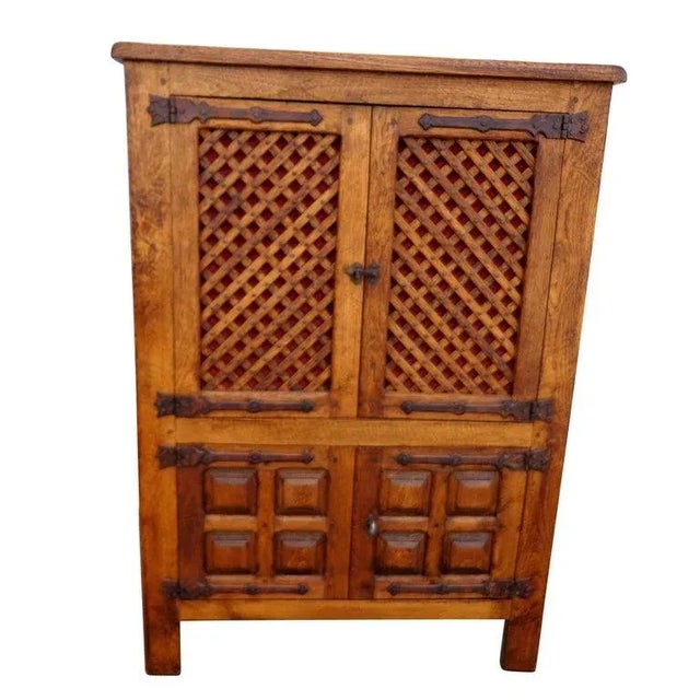 Large Chinese Country cabinet Handsome solid elmwood cabinet, having lattice front cabinet doors and three shelves.