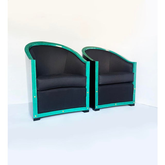 Particular pair of 1930s decò style armchairs with structure entirely in black lacquered wood and perimeter characterized...