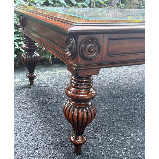 Gorgeous Ethan Allen British Classics coffee table with an inset glass top over a hand-woven cane surface.Features a...