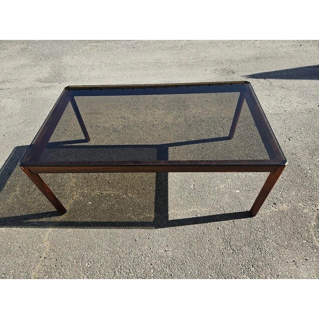 Beautiful Mid-Century Modern coffee table featuring a rare, beautifully grained Brazilian rosewood frame paired with a...