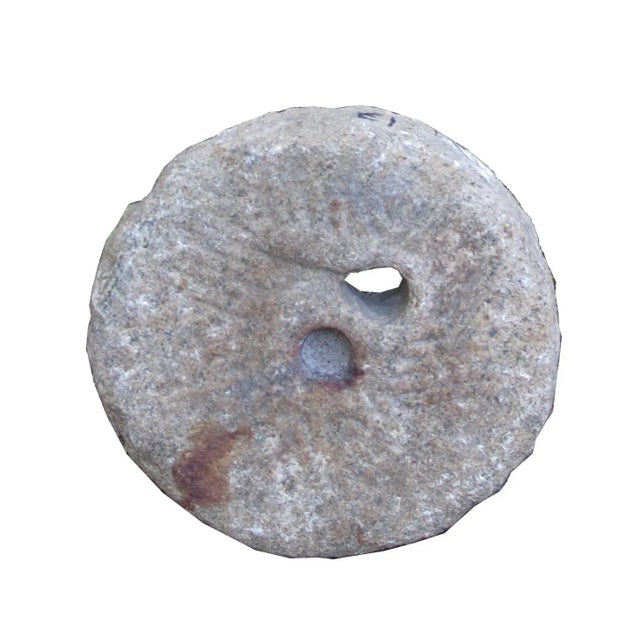 This top of a watermill stone was retrieved from the northern part of China. It was originally used for grinding grains....