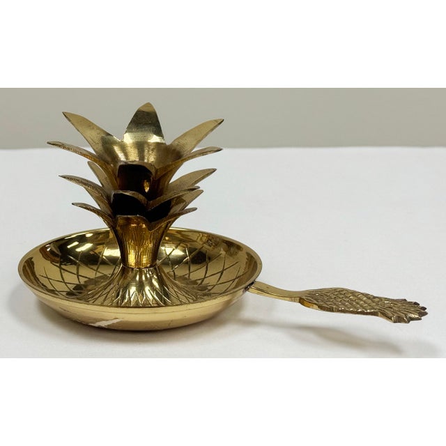 Vintage brass pineapple candlestick holder with pineapple motif handle and exaggerated plume. Charming and practical, this...