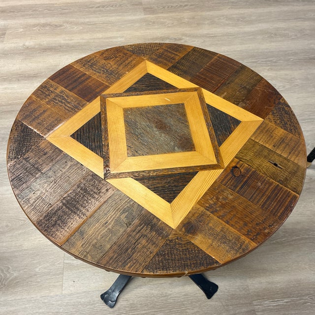 Heavy wrought iron table with uniques wood pattern designed by Tim McClellan