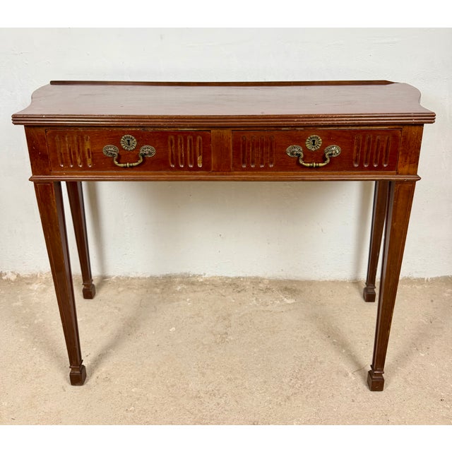 Elegant Spanish console table crafted in wood during the late 20th century. The piece features a long rectangular top...