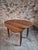 Antique French drop-leaf table in walnut, dating from the late 19th century. The table features an oval top made from...