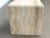 Sculptural vintage travertine cube side table featuring beautiful natural veining in warm ivory, beige, and cream tones....