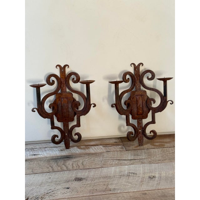 Beautifully textured pair of scroll candelabra sconces. Very heavy and dramatic. Contrasts very nicely installed on a...