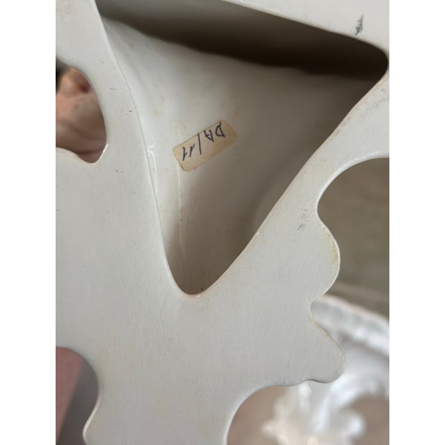 A beautiful pair of vintage white glazed ceramic wall brackets featuring elegant Rococo-inspired styling. Each bracket is...