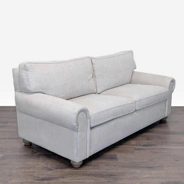 This Restoration Hardware sleeper sofa offers both style and practicality. With its clean, light gray fabric and classic...