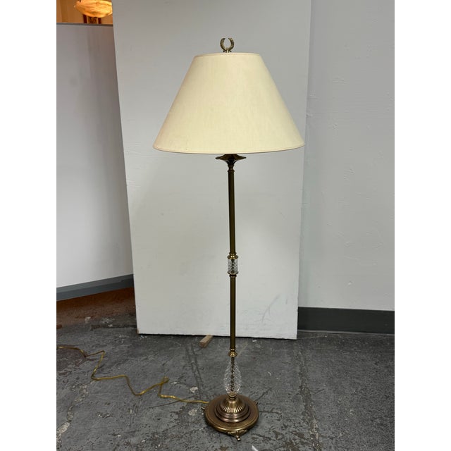Design Plus Gallery presents a Vintage Floor Lamp. This vintage floor lamp has a brass-tone metal frame with clear cut...