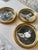 A charming trio of vintage round gold frames, each encasing a timeless black-and-white baby portrait [these can be...