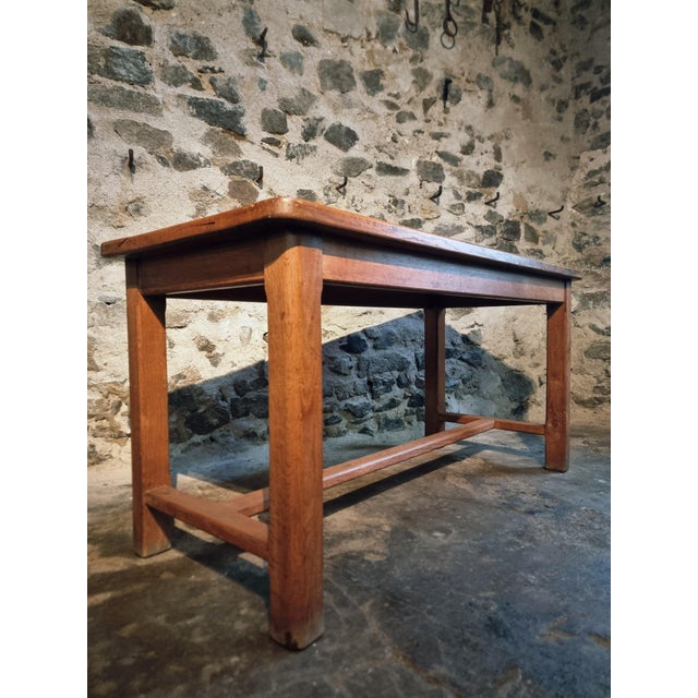 This French oak table from the 1960s reflects the restrained, functional design typical of mid-20th-century utility...