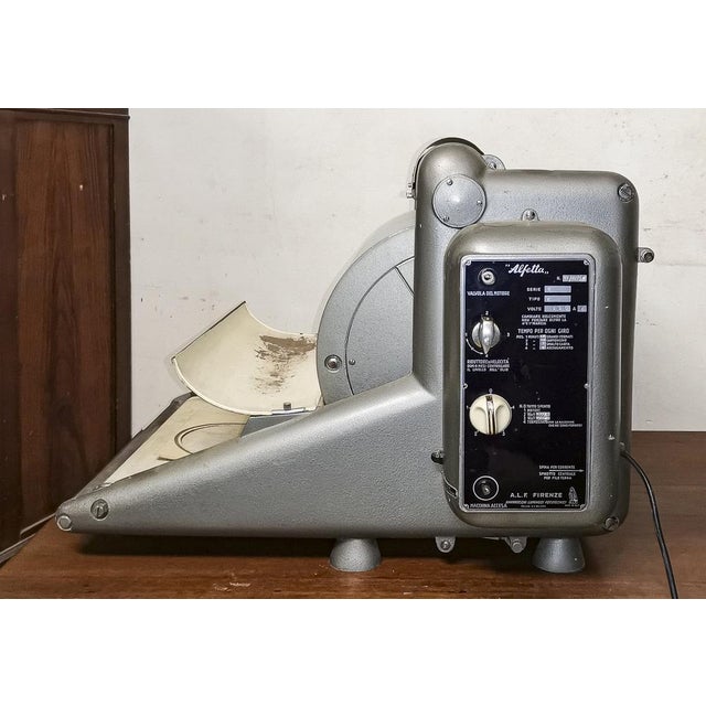 Alfetta photographic studio enamelling machine. The machine has a mud-grey, pewter-finish metal structure, with a steel...