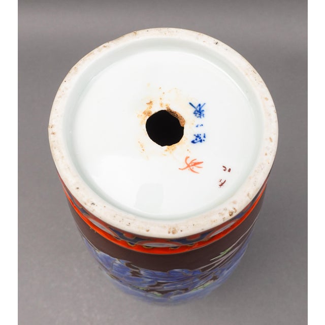 Chinese Signed Old Cloisonne On Porcelain Floral Foo Dogs Vase. Measures approximately 5 1/2" diameter, 13 3/4" high.