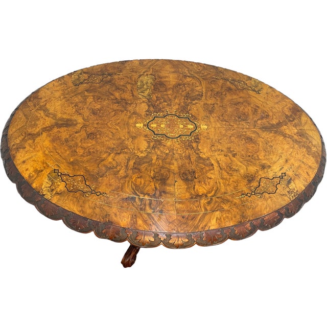 Napoleon III style tilt-top entry table showcasing exceptional craftsmanship. The table features a three-leg base carved...