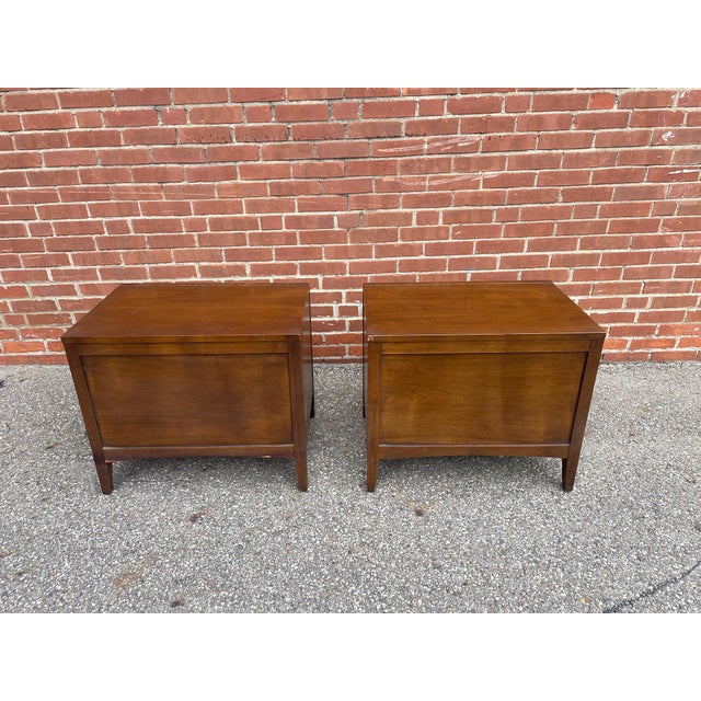 Pair of walnut nightstands from Broyhill’s “Emphasis” collection. A strong late mid-century design with clean lines,...