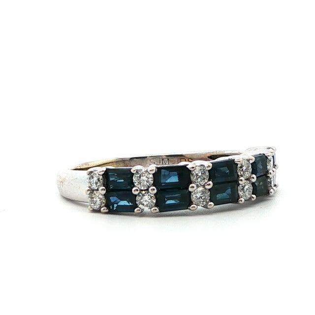 This beautiful 14k white gold band was made with bright white round cut diamonds and rich blue baguette cut sapphires....