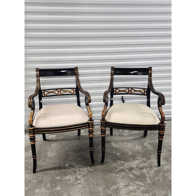 A striking and highly decorative pair of Regency style armchairs by Maitland-Smith, a luxury high-end quality brand known...