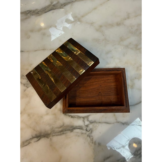 A distinctive Italian decorative box crafted from richly grained wood and accented with hand-applied vertical brass bands...