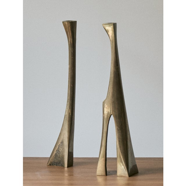 Pair of Mid-Century Modern solid brass candlesticks, Scandinavian. The candleholders feature a sculptural, organic shape,...