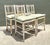 This set of four vintage faux bamboo spindle back chairs beautifully captures the enduring appeal of late 19th-century...