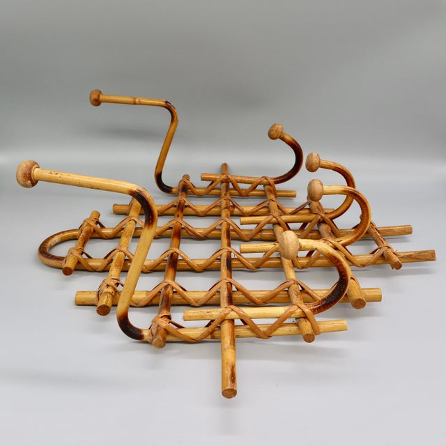 A striking piece of French mid-century design — a lattice-form coat and hat rack in scorched bamboo with rattan-wrapped...