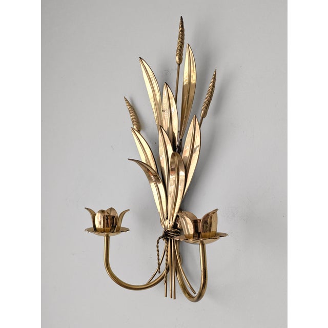 A vintage Hollywood Regency style brass candle sconce with wheat motif and two candle holders.