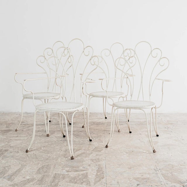 Set of four vintage white-painted iron armchairs, attributed to Lio Carminati, an Italian designer known for his outdoor...