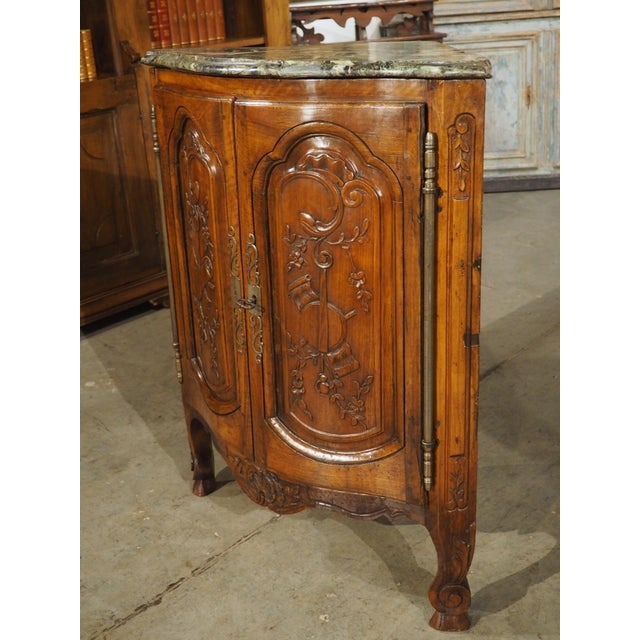 More information coming soon… This French corner cabinet from the 1700s is adorned with musical trophies on the two doors....