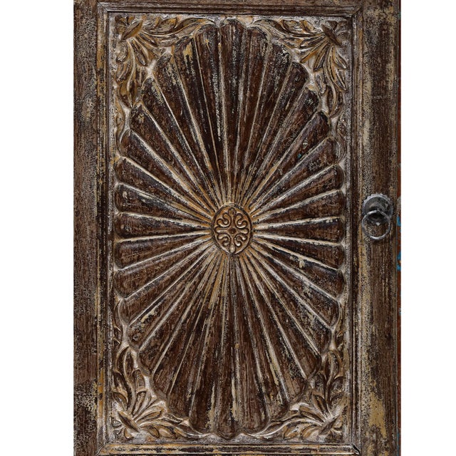 Constructed from recycled antique Indian teak elements, with a sunburst carved door panel on the front and old paneled...