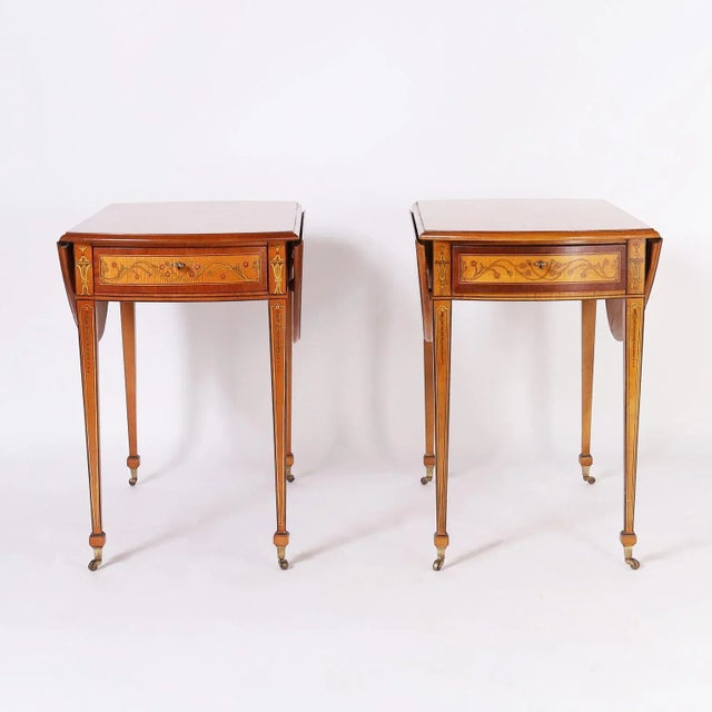 Dashing pair of one drawer drop leaf tables crafted in maple with mahogany cross banding in an elegant form with...