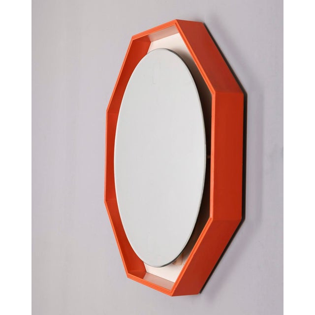 Backlit wall mirror with octagonal orange wooden frame, italian design, 1970s. condition: in good condition, fully...