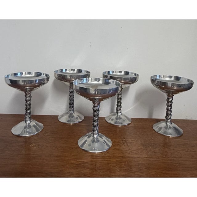 Set of 5 vintage Plator Silverstone silverplate goblets made in Spain. Features shallow coupe bowls with ornate grapevine-...