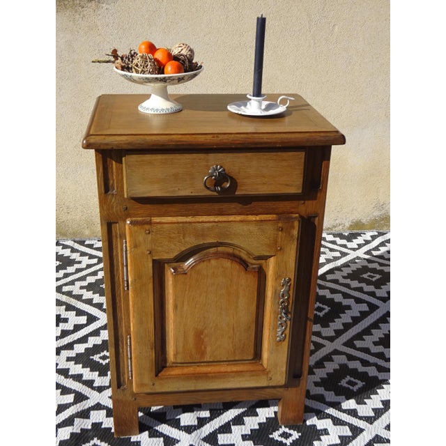 Solid oak top with rounded edges, sanded and varnished with a matte clear finish. One storage drawer with an aged metal...