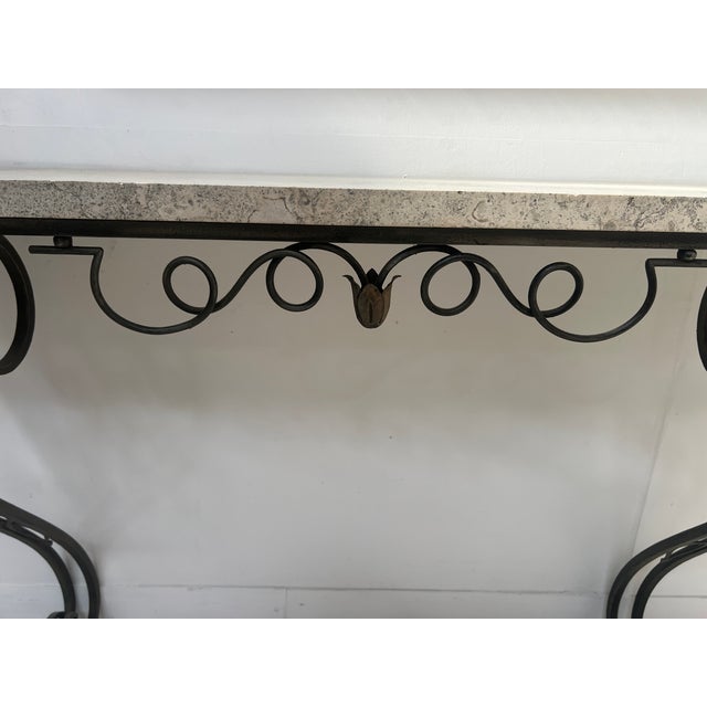 Art Deco style console table in hammered wrought iron Two curved legs with a geometric motif Breccia marble top Good...