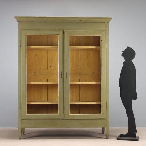 Directoire walnut wardrobe, lacquered and painted. Front with a pair of glass doors, glass panels replacing the original...
