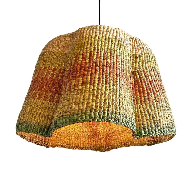 Hand dyed lime green, orange, and natural hand woven grass basket lamp. Unique and striking piece with hand woven patterns...