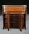 A smart regency amboyna side cabinet well figured top with raised structure supported by brass columns and grills topped...