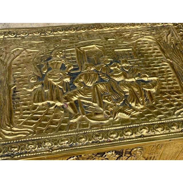 This is a sweet small sized embossed brass box with a Victorian style tavern inside and outside scene that would have...