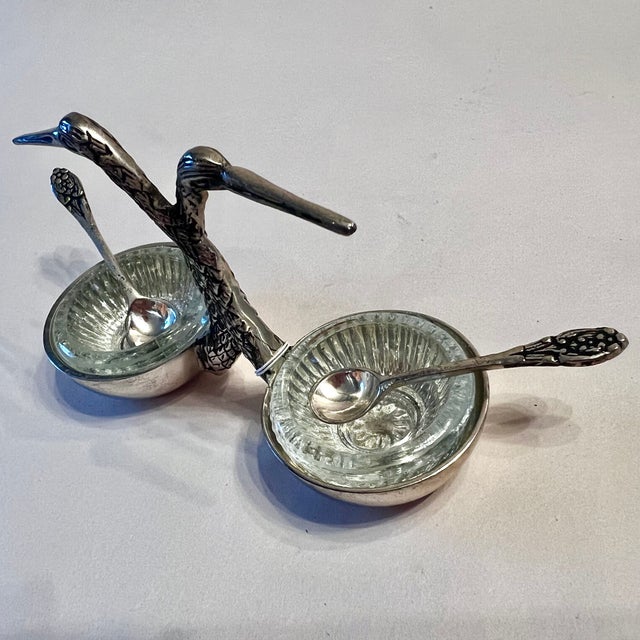 An elegant tabletop serving piece inspired by classic vintage entertaining accessories. Featuring a sculptural pair of...