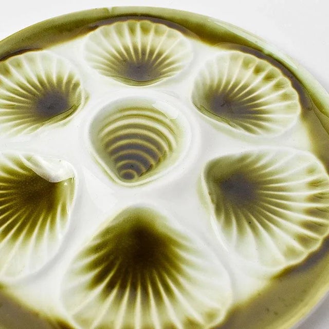 Set of six Moulin des Loups green and cream majolica oyster platters from France by Orchies. These round platters have a...
