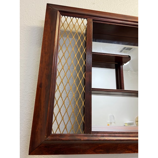 This beauty is a Fantastic, mid-century modern, extra large shadow box mirror with side expanded brass tone accents. The...