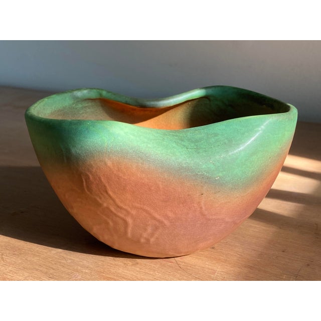 A wonderful 1930s Weller Pottery bowl in a muted Orange/Tangerine glaze with Green Trim. Marked Weller Pottery on the...