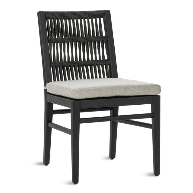 Modern outdoor dining chair with a solid mahogany frame finished in a deep charcoal black tone, handwoven synthetic rope...