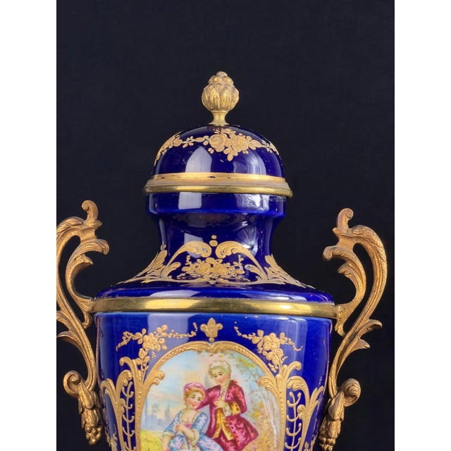 Elegant French porcelain urn with cover, created in the refined Sèvres style in late 19th-century Paris. The piece...