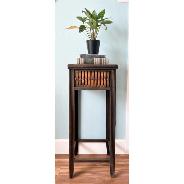 Charming, Asian bamboo pedestal or plant stand featuring a tall, slender silhouette and beautifully aged dark-brown...