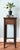 Charming, Asian bamboo pedestal or plant stand featuring a tall, slender silhouette and beautifully aged dark-brown...