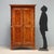 Two-part larch wardrobe dating back to the mid-19th century, crafted in Italy. The structure features a pair of bipartite...